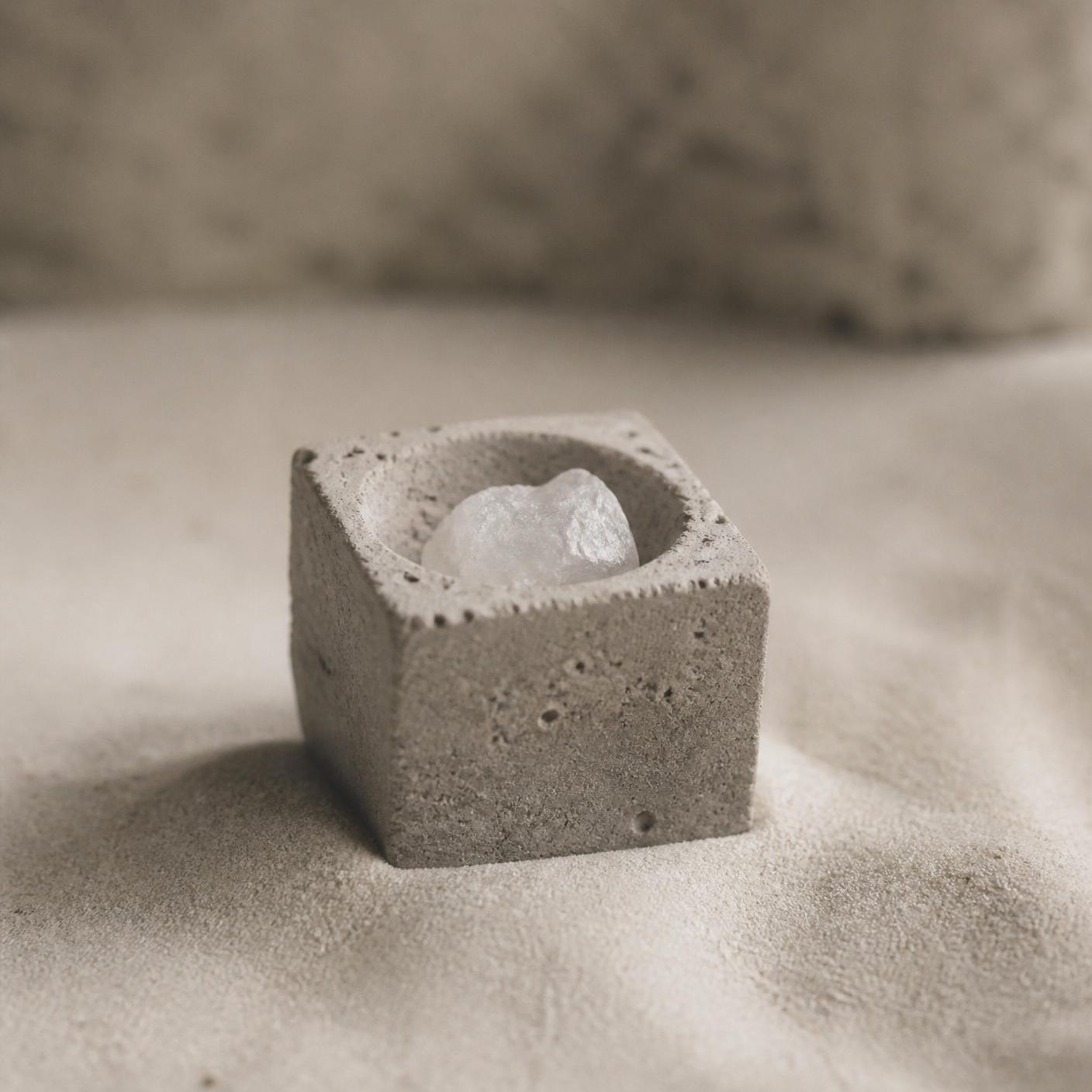 Album artwork — a small pile of salt on warm concrete